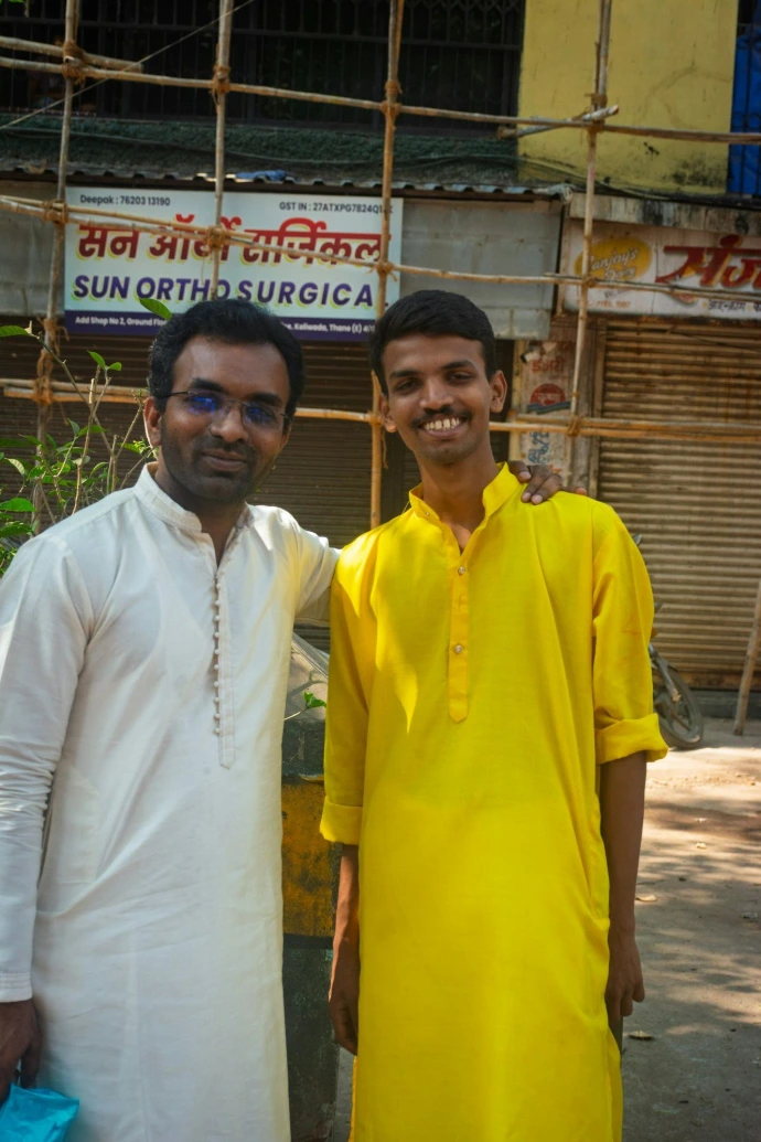 Two men in traditional indian clothing stand outside